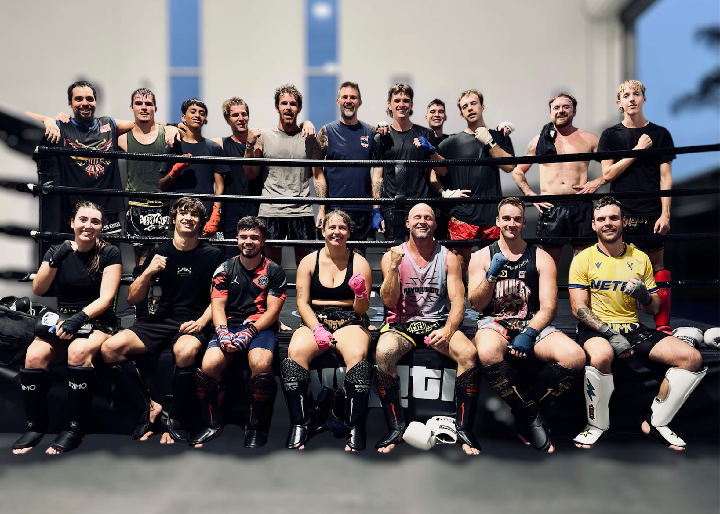 Revolution Muay Thai members smiling together in the ring